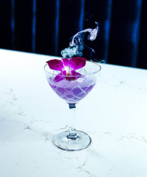 The Aviation cocktail, with bombay sapphire gin, lemon, maraschino liqueur, and crème de violette.